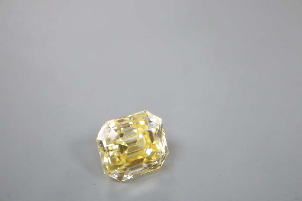 An unmounted emerald cut yellow gemstone, possibly cubic zirconia, weighing approximately 29.00ct.